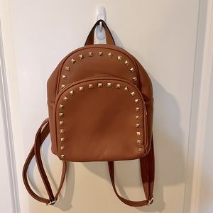 Tan leather with gold studded mini backpack.